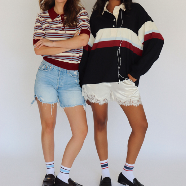 Two models wearing retro striped and block-color polo shirts and shorts, standing against a plain white studio background.