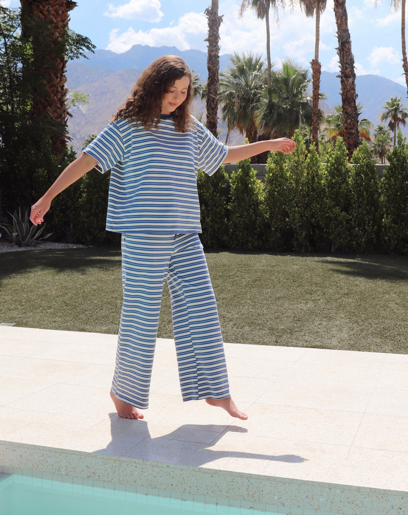 woman wearing blue and white striped set in an outdoor setting