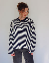 Person wearing a navy and white striped top against a plain background.
