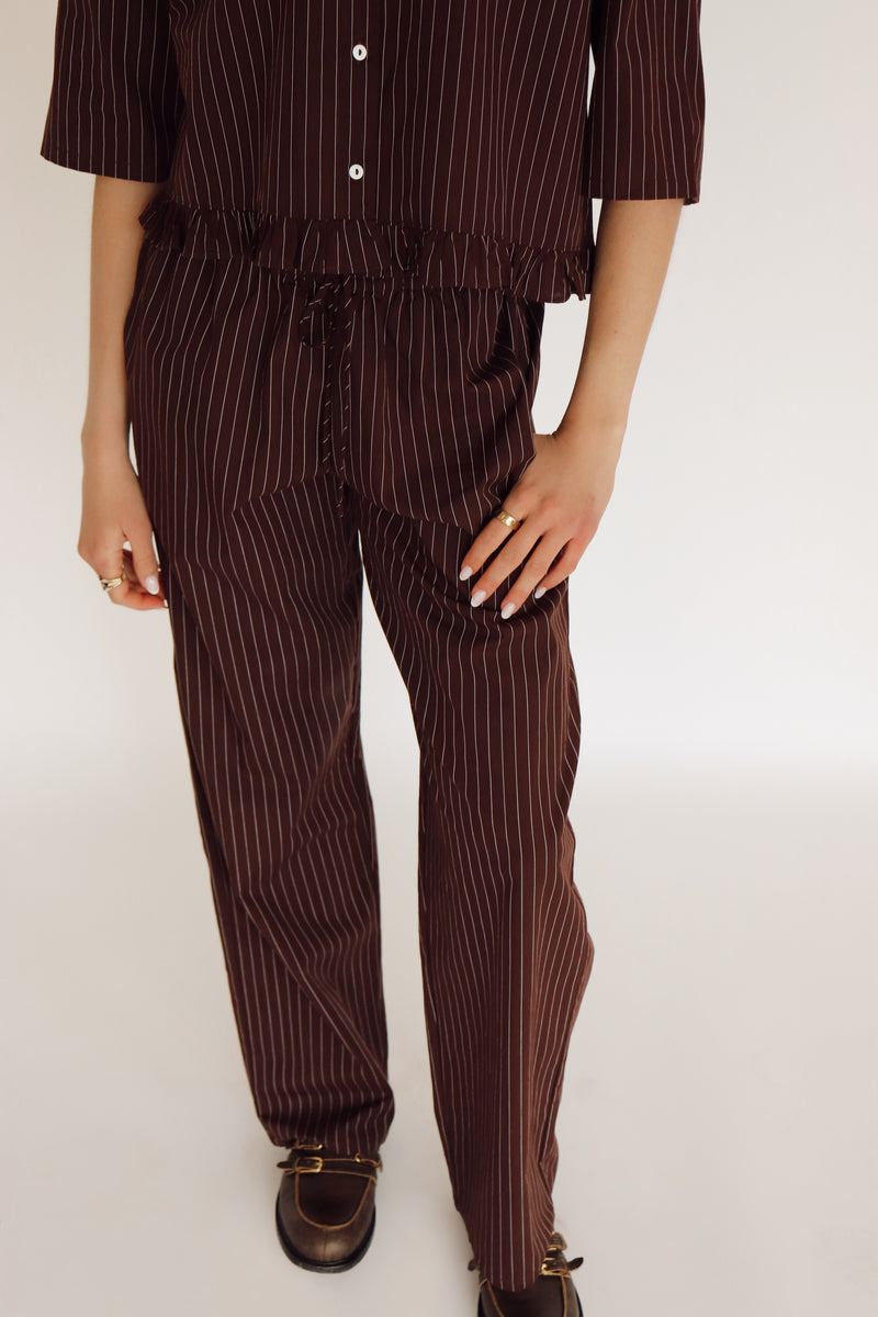 Person wearing a brown set with white stripes.