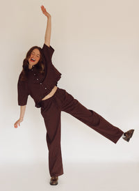 Person wearing a brown set with white stripes.