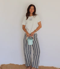 Woman holding a small blue bucket against a plain white background
