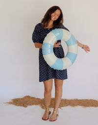 Woman in a navy dress with blue polka dots 