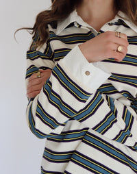 Woman wearing a striped long-sleeve shirt with a white background