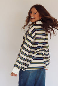 Woman wearing a striped long-sleeve shirt with a white background