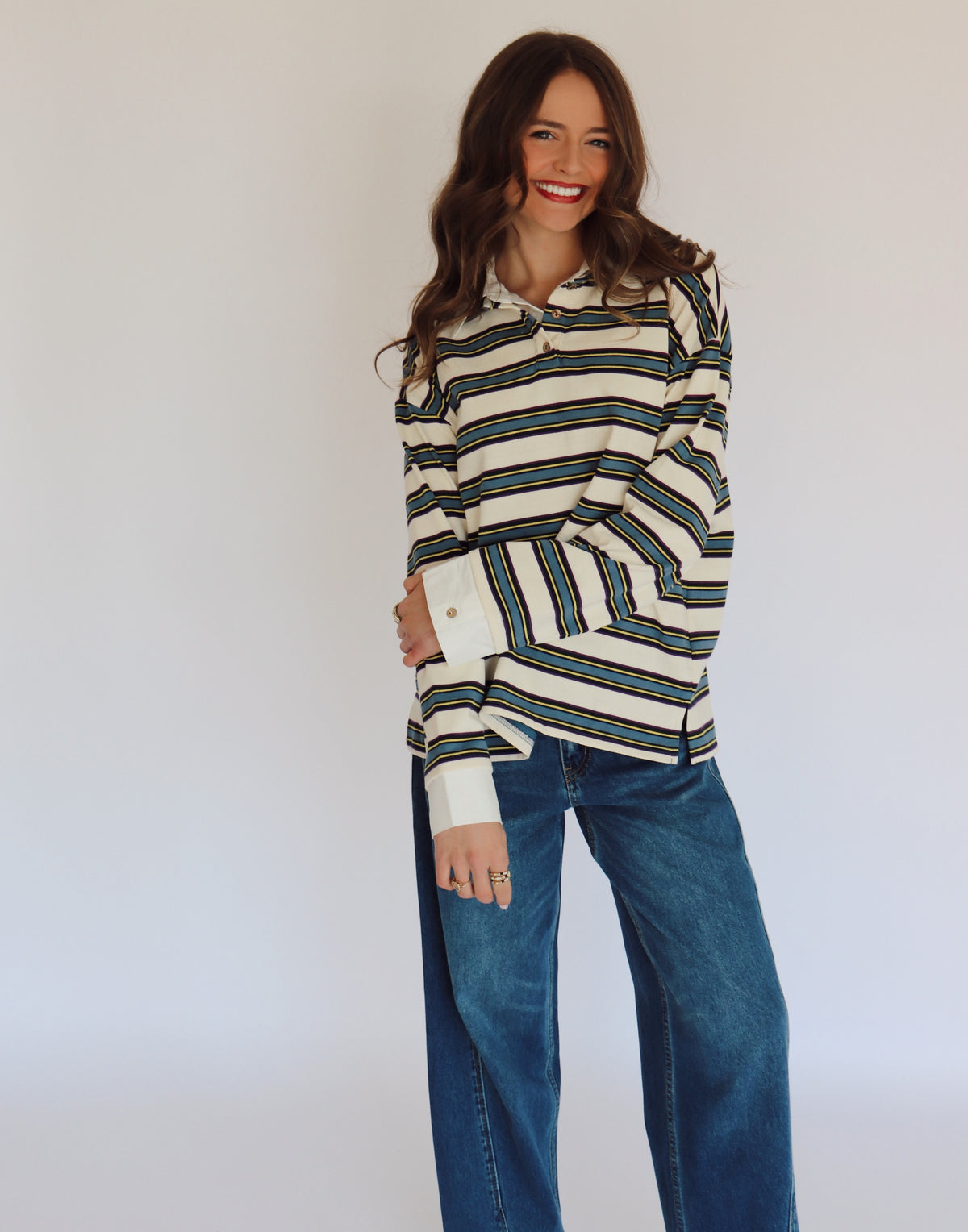 Woman wearing a striped long-sleeve shirt with a white background