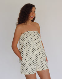 woman wearing a polka dot set against a plain background