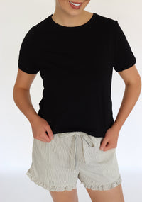 woman wearing a black tee shirt and striped shorts