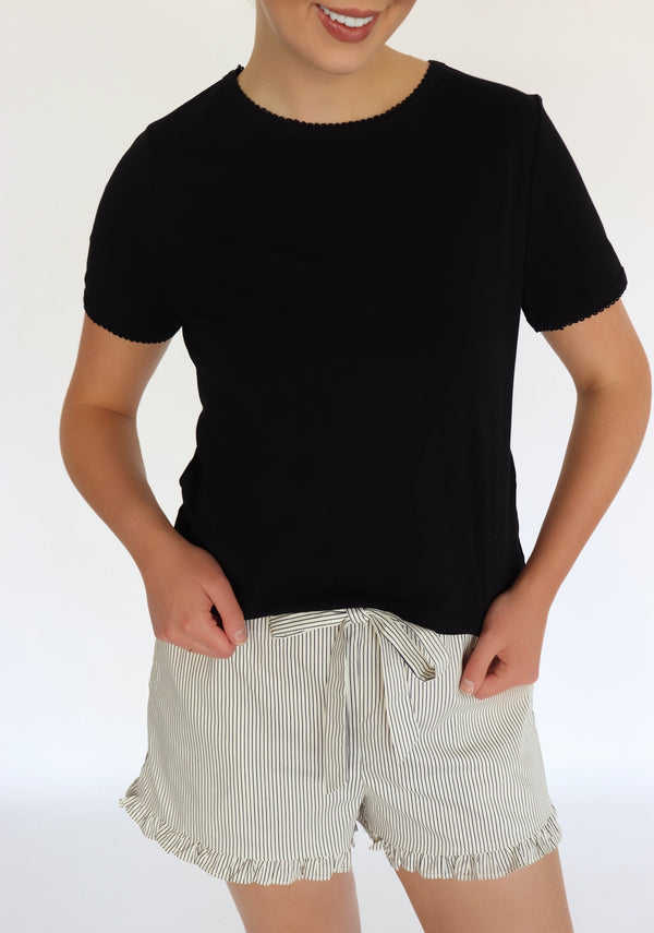 woman wearing a black tee shirt and striped shorts
