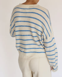 woman wearing striped blue and off white cardigan 
