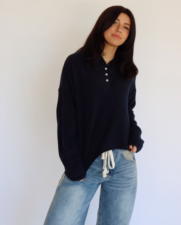 Person wearing a blue top and blue jeans against a white background