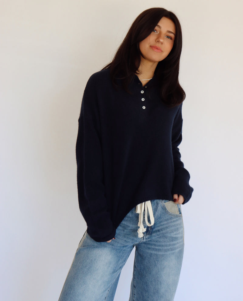 Person wearing a blue top and blue jeans against a white background
