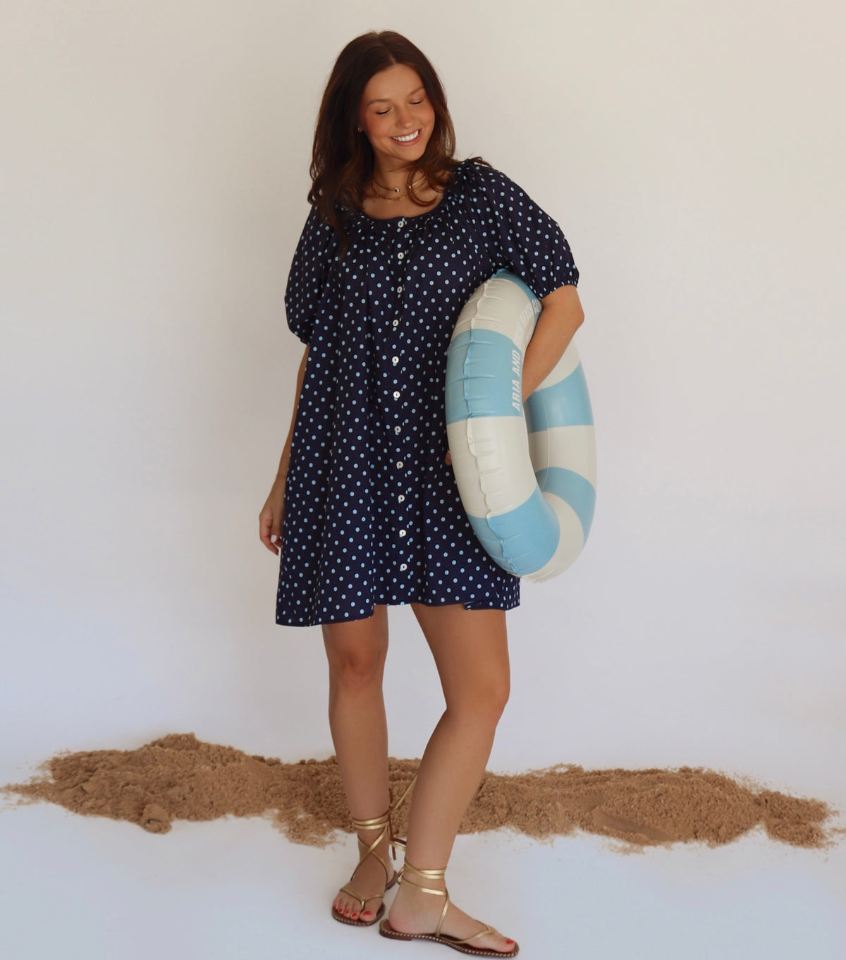 Woman in a navy dress with blue polka dots 