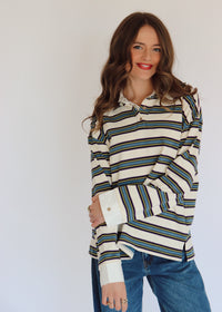 Woman wearing a striped long-sleeve shirt with a white background