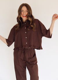 Person wearing a brown set with white stripes.