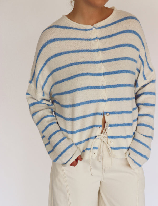 woman wearing striped blue and off white cardigan 
