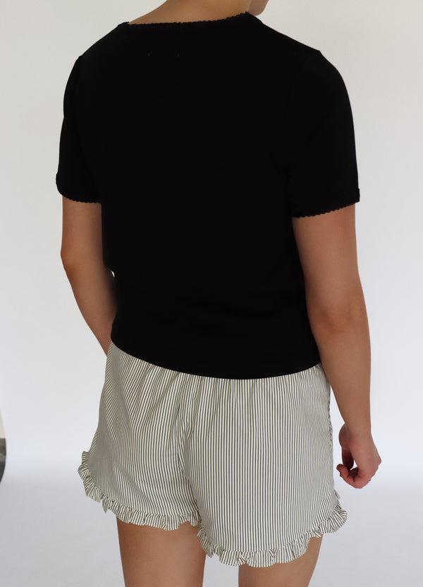 woman wearing a black tee shirt and striped shorts