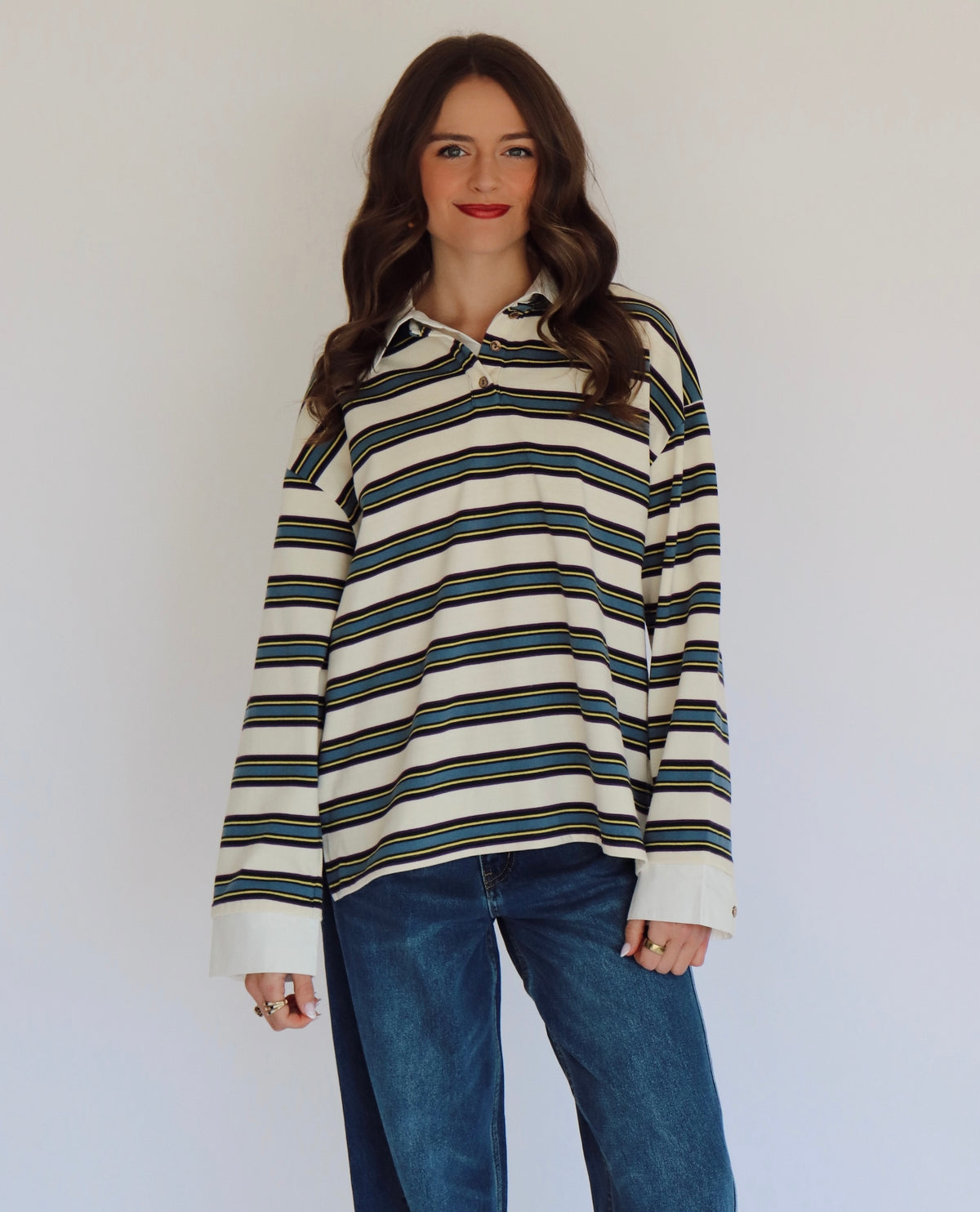 Woman wearing a striped long-sleeve shirt with a white background